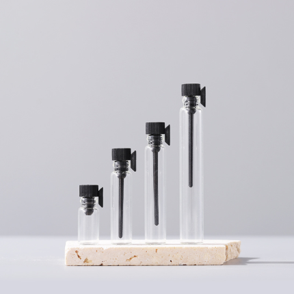 Clear glass sample vials with black caps and dropper applicators, size lineup