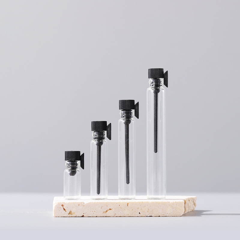 Clear glass sample vials with black caps and dropper applicators, size lineup