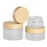 Frosted glass bottles and cream jars with woodgrain caps
