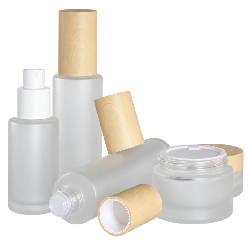 Frosted glass bottles and cream jars with woodgrain caps