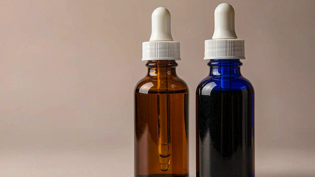 Amber and cobalt blue dropper bottles side by side