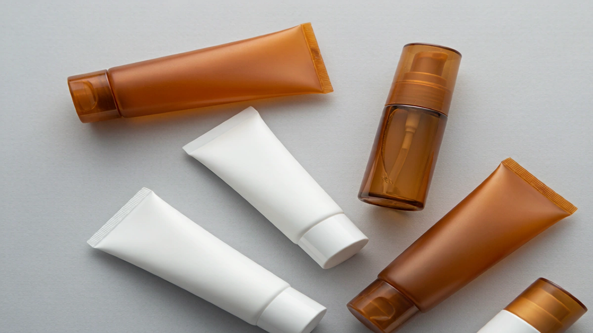 Assortment of cosmetic squeeze and airless tubes on a clean studio surface