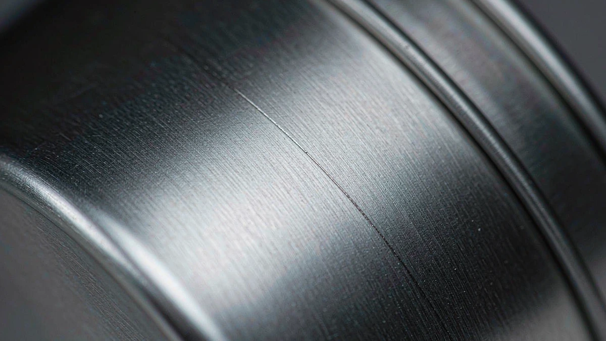 Close-up of anodized aluminum cosmetic jar surface showing premium matte metal texture