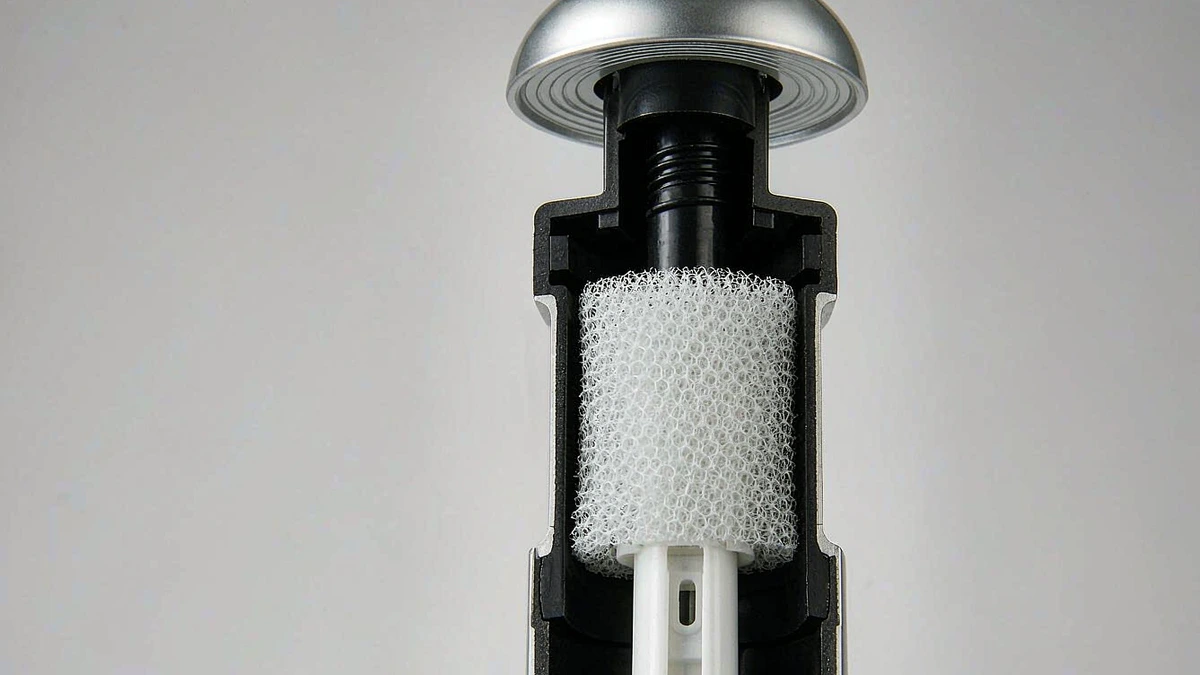Cutaway view of a foam pump dispenser showing actuator, chamber and mesh screen insert